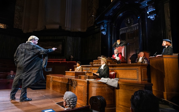 Courtroom scene from "Witness for the Prosecution" performance with actors in period costumes.
