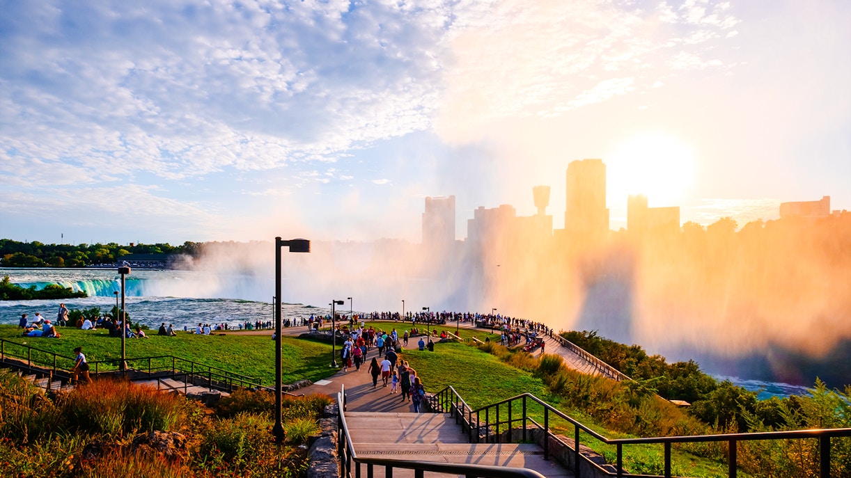 Visitors at Terrapin Point, Niagara Falls, viewing the waterfall mist and city skyline.