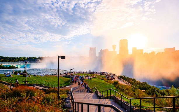 Visitors at Terrapin Point, Niagara Falls, viewing the waterfall mist and city skyline.