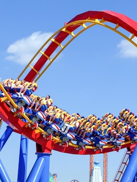 Roller coaster loop with riders at Parque Warner Beach, Madrid.