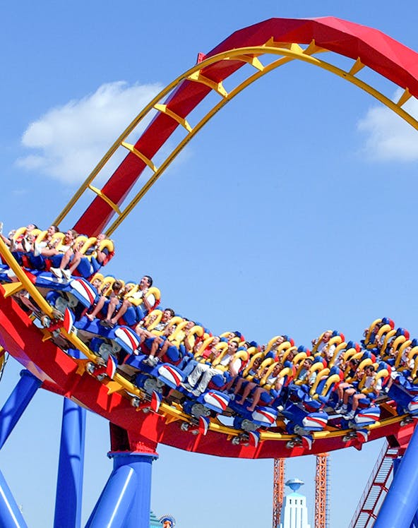 Roller coaster loop with riders at Parque Warner Beach, Madrid.