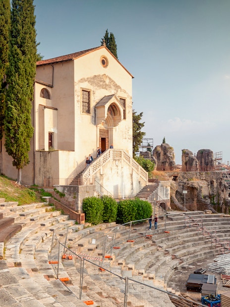 Teatro Romano Verona with ancient stone seating and nearby historic buildings.