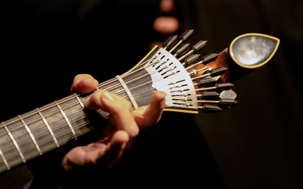 Fado guitarist playing traditional Portuguese guitar in Lisbon.