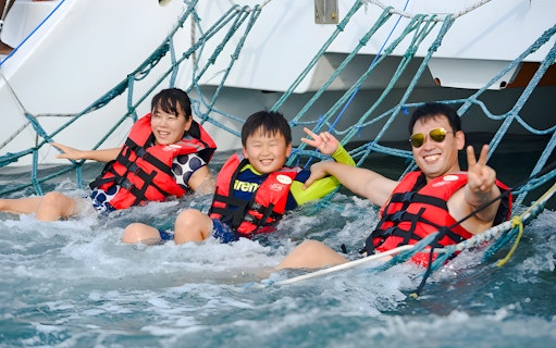 Family enjoying netting on Langkawi sunset cruise.