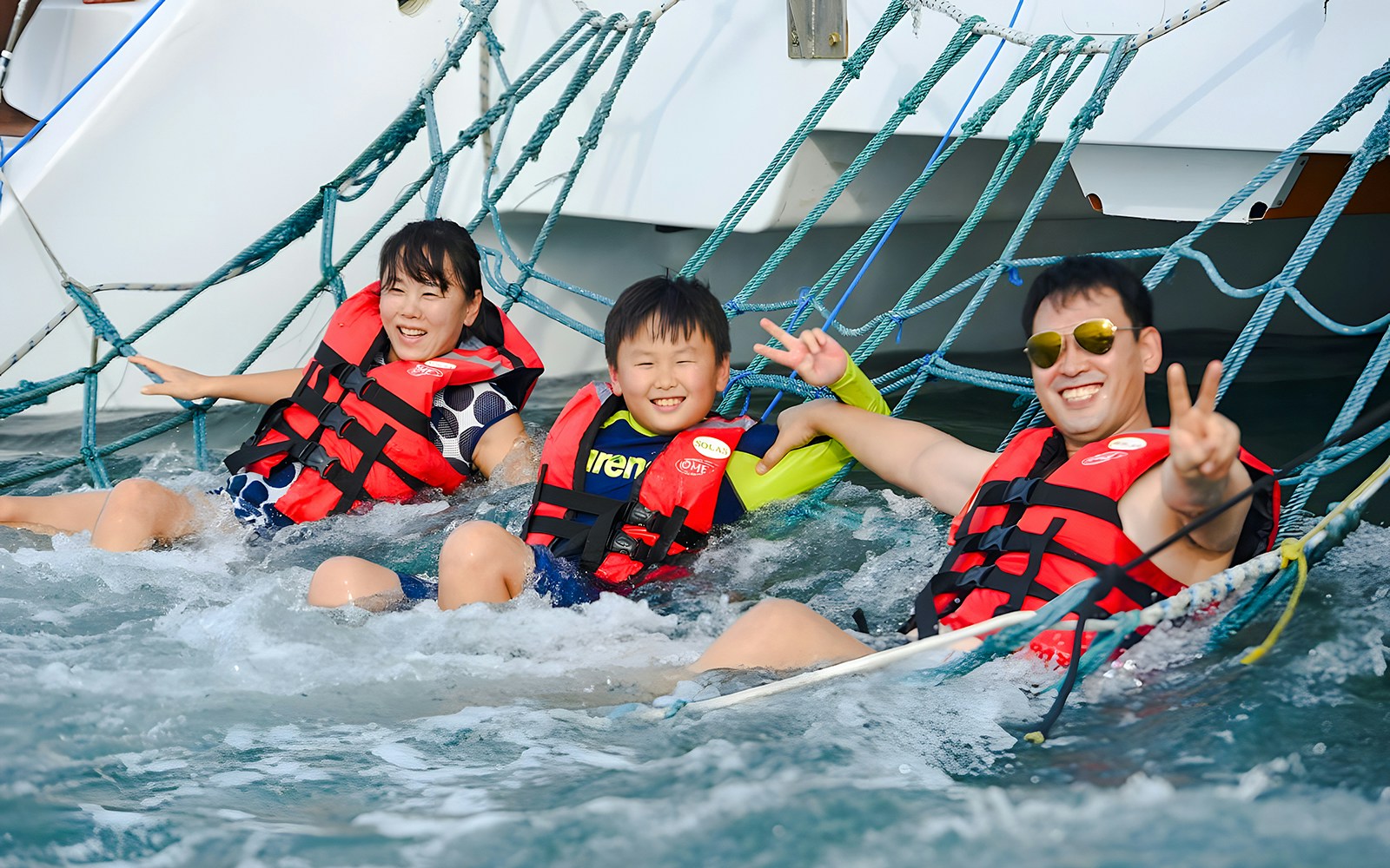 Family enjoying sunset on Langkawi cruise with hotel transfers.