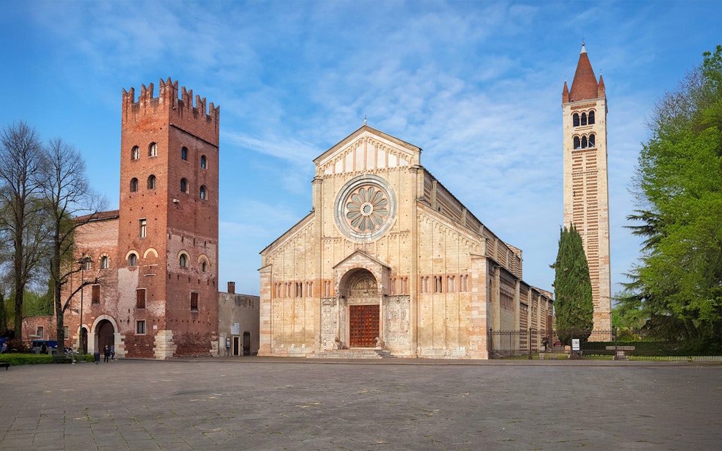 Basilica San Zeno Maggiore in Verona with its distinctive rose window and bell tower.