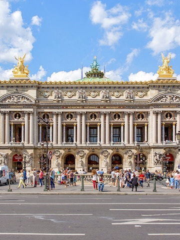 Opera Garnier facade with visitors in Paris, France.