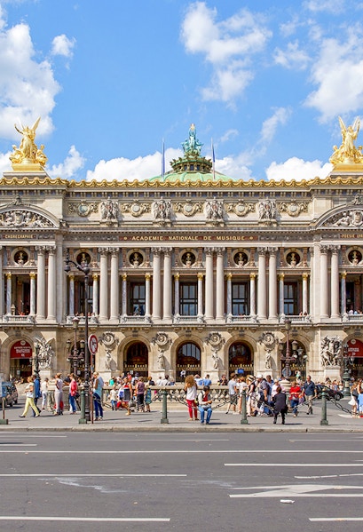 Opera Garnier facade with visitors in Paris, France.