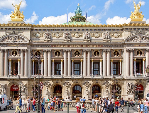 Opera Garnier facade with visitors in Paris, France.