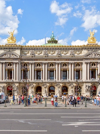 Opera Garnier facade with visitors in Paris, France.