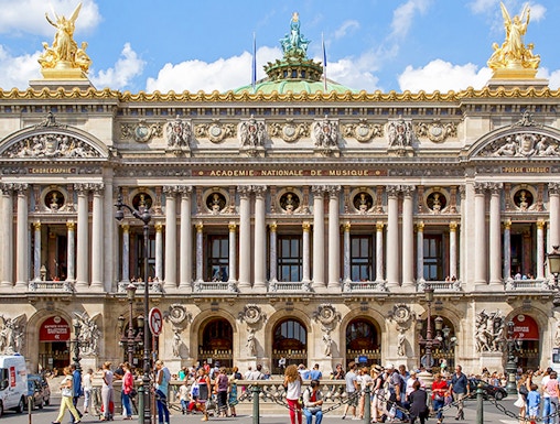 Opera Garnier facade with visitors in Paris, France.