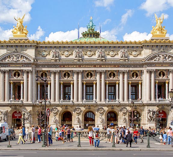 Opera Garnier facade with visitors in Paris, France.