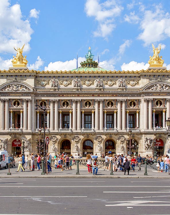 Opera Garnier facade with visitors in Paris, France.