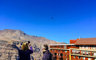 Tourists photographing Andes Mountains near Santiago.