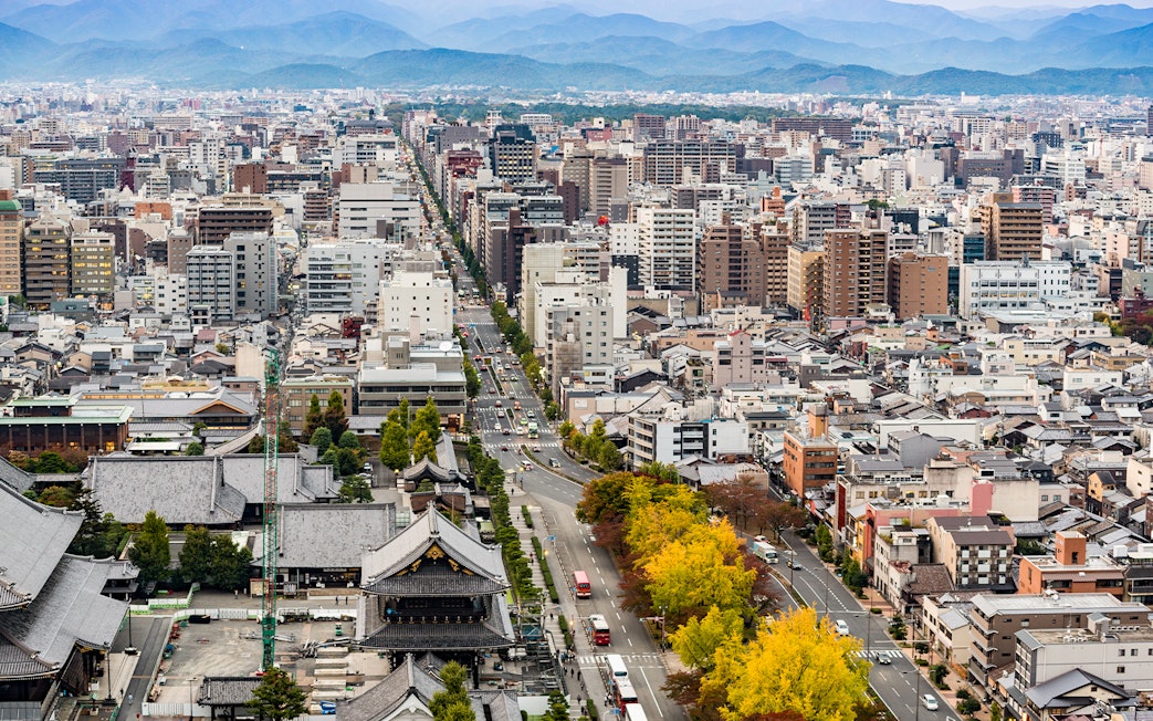 Kyoto cityscape view from Kyoto Tower with distant mountains.