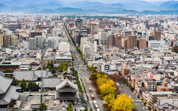 Kyoto cityscape view from Kyoto Tower with distant mountains.