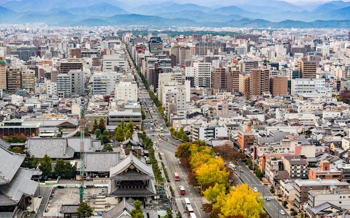 Kyoto cityscape view from Kyoto Tower with distant mountains.