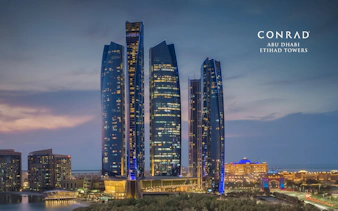 Etihad Towers in Abu Dhabi at dusk, part of the Abu Dhabi tour from Dubai.