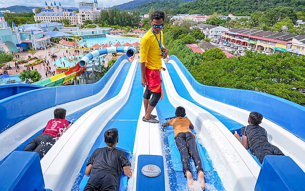 Visitors enjoying water slides at Splash Out Langkawi Water Theme Park, Malaysia.