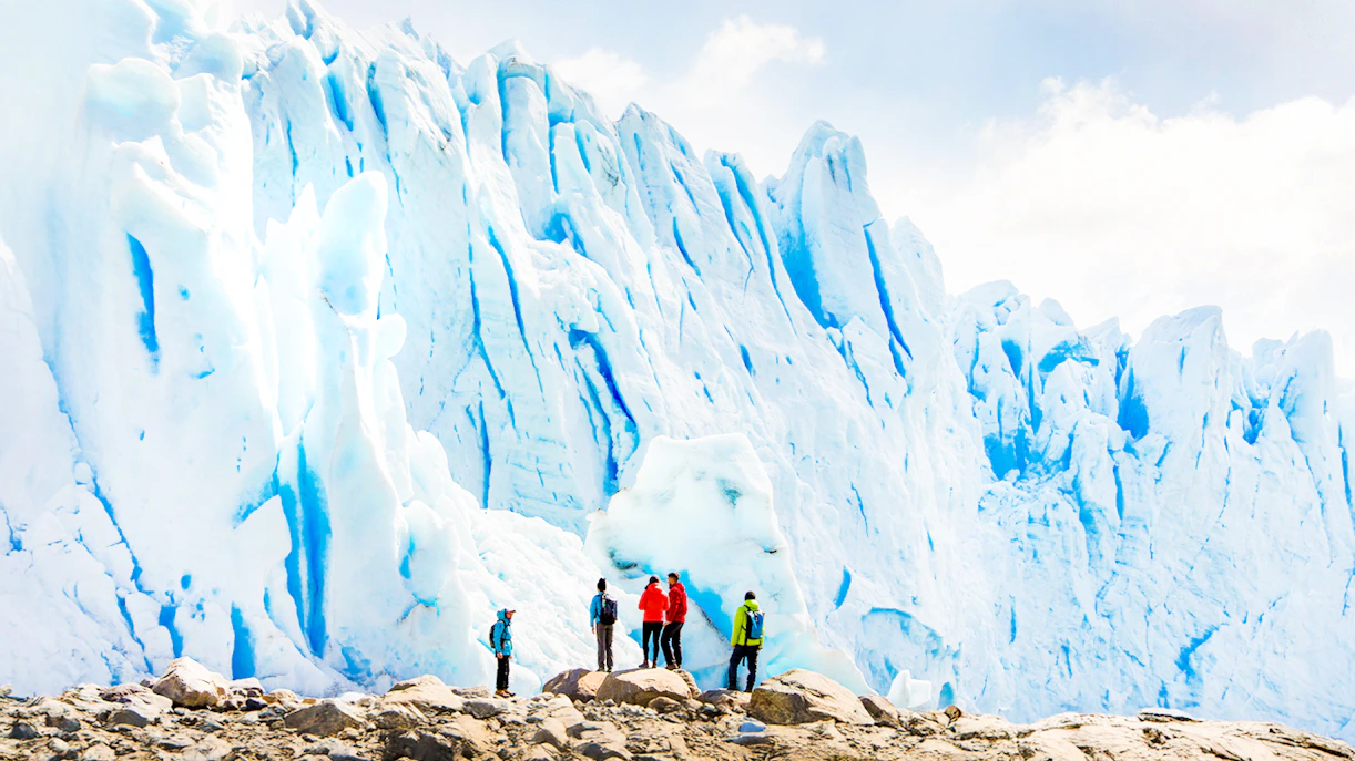 Tourists with guide hiking near Perito Moreno Glacier, Argentina.