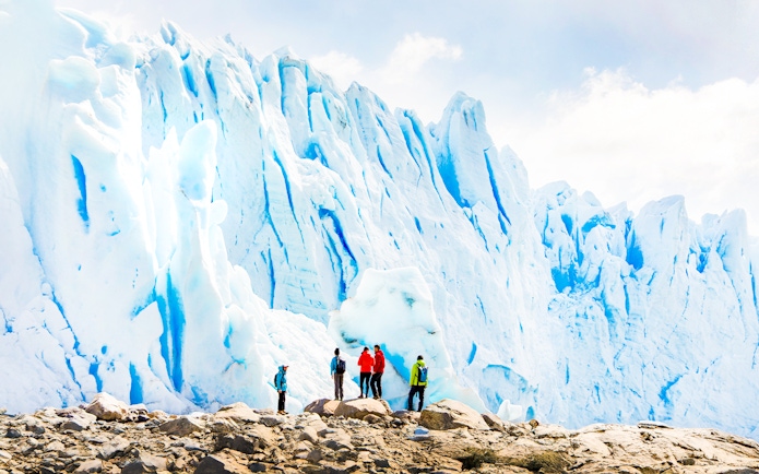 Tourists with guide hiking near Perito Moreno Glacier, Argentina.