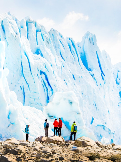 Tourists with guide hiking near Perito Moreno Glacier, Argentina.
