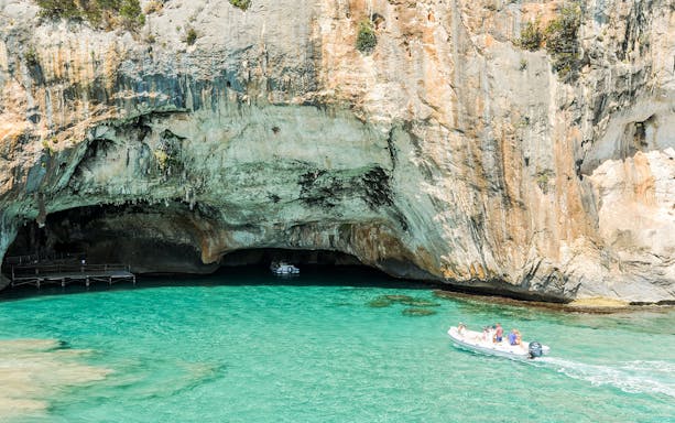 Boat tour near Favignana cave with turquoise water.
