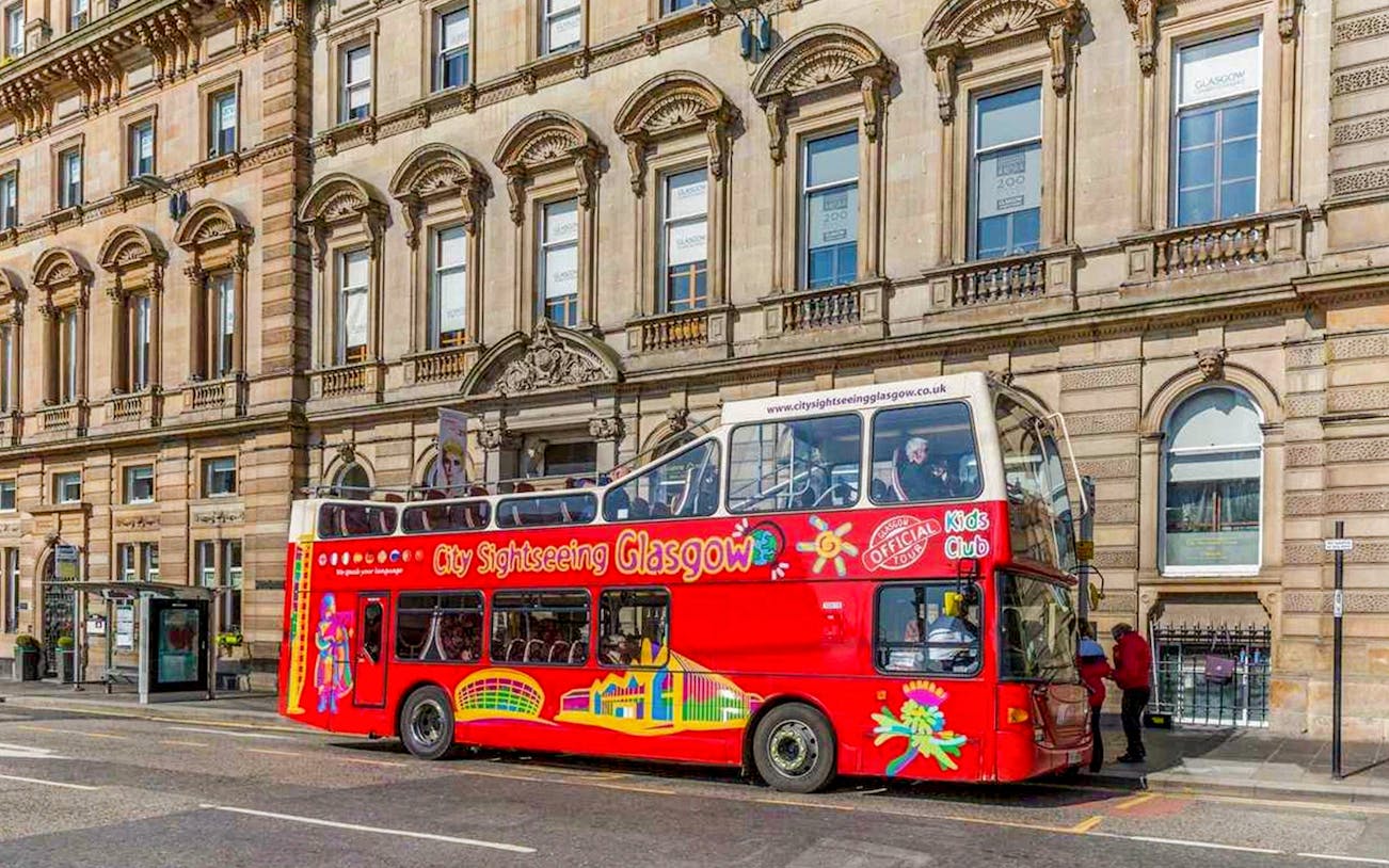 Open-top sightseeing bus in Glasgow city center.