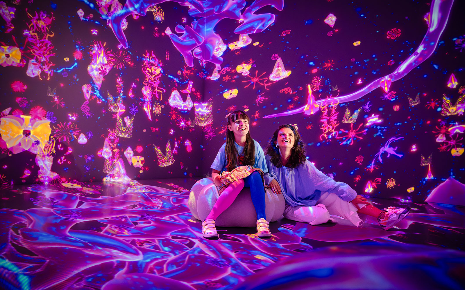 Tourists enjoying immersive digital art at House of Hype, Dubai.