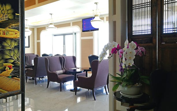 Coral Executive Lounge seating area with orchids at Phuket International Airport T1 Domestic.