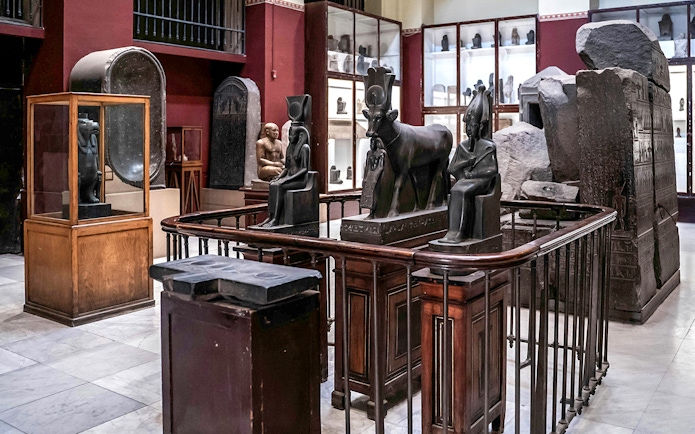 Ancient Egyptian statues and artifacts displayed in the Grand Egyptian Museum.