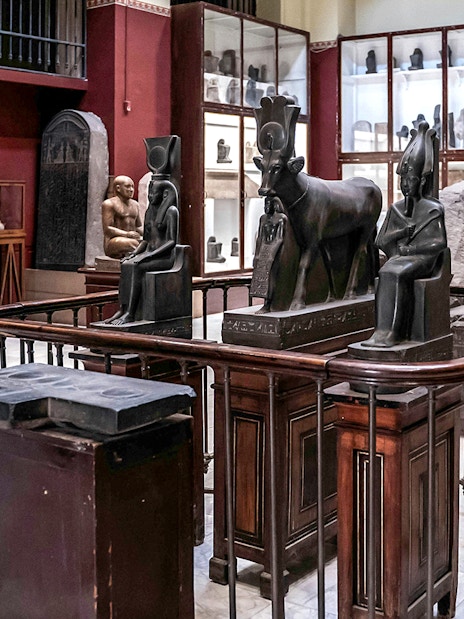 Ancient Egyptian statues and artifacts displayed in the Grand Egyptian Museum.