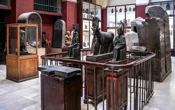 Ancient Egyptian statues and artifacts displayed in the Grand Egyptian Museum.