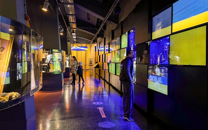 Visitors exploring exhibits inside La Bombonera stadium museum in Buenos Aires.