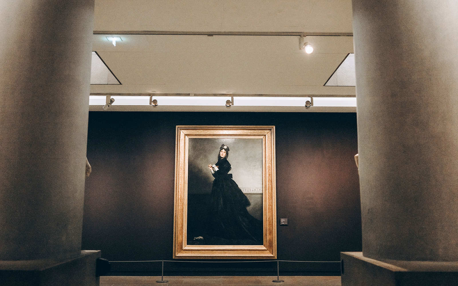 Painting of a woman in black dress at Orsay Museum, Paris.