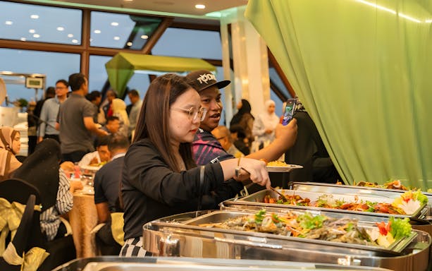 Buffet guests serving food during Ramadan at KL Tower.