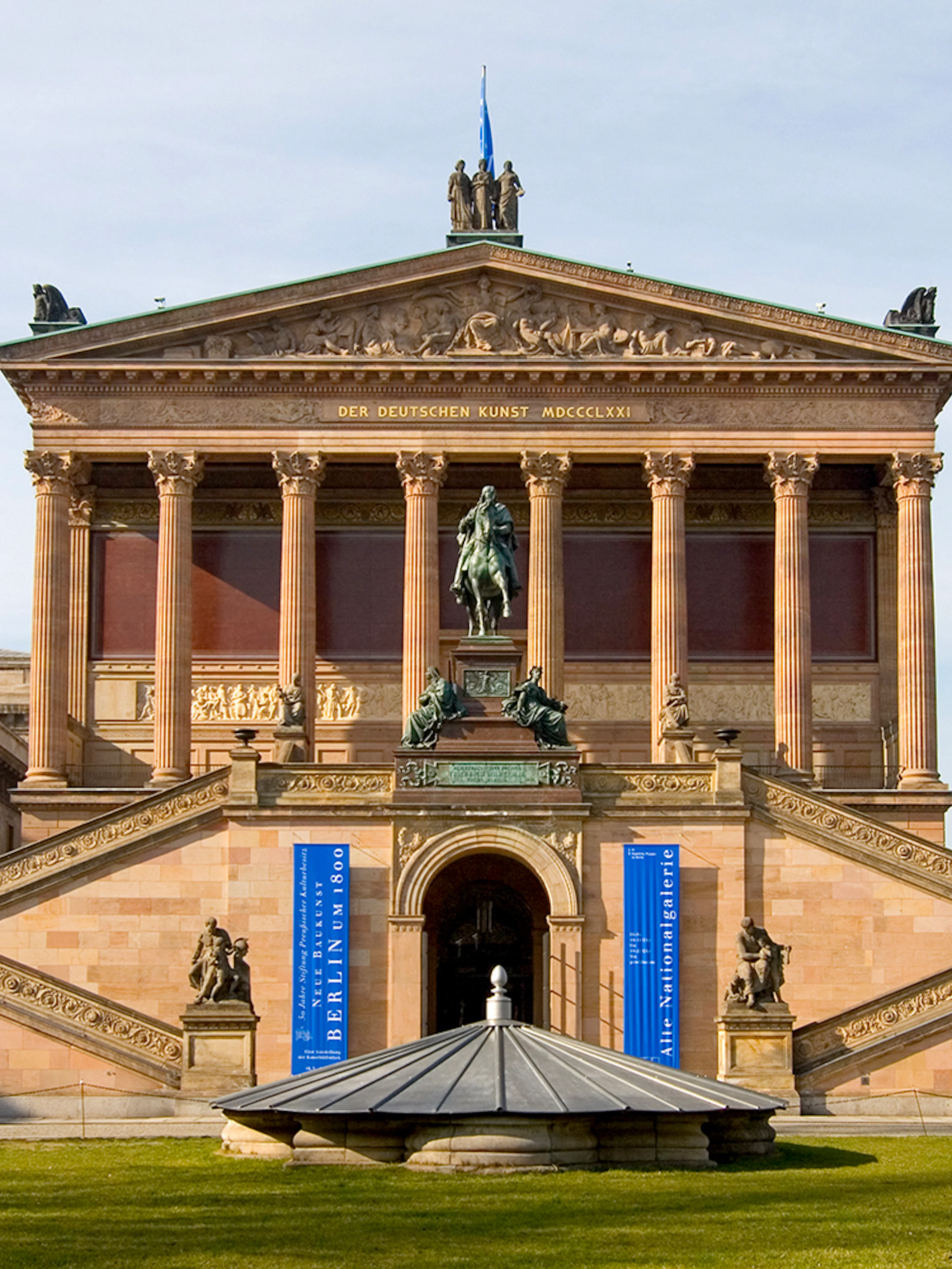 Alte Nationalgalerie facade with statue and grand staircase in Berlin.