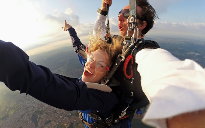 Paragliding tandem flight over Interlaken with scenic aerial view.