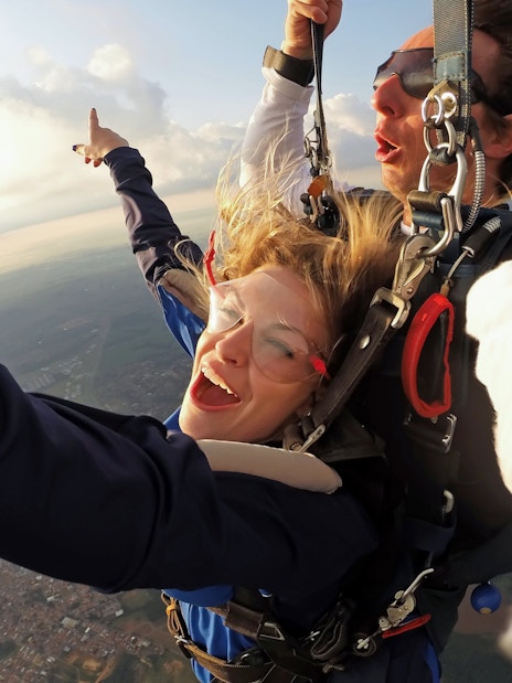 Paragliding tandem flight over Interlaken with scenic aerial view.
