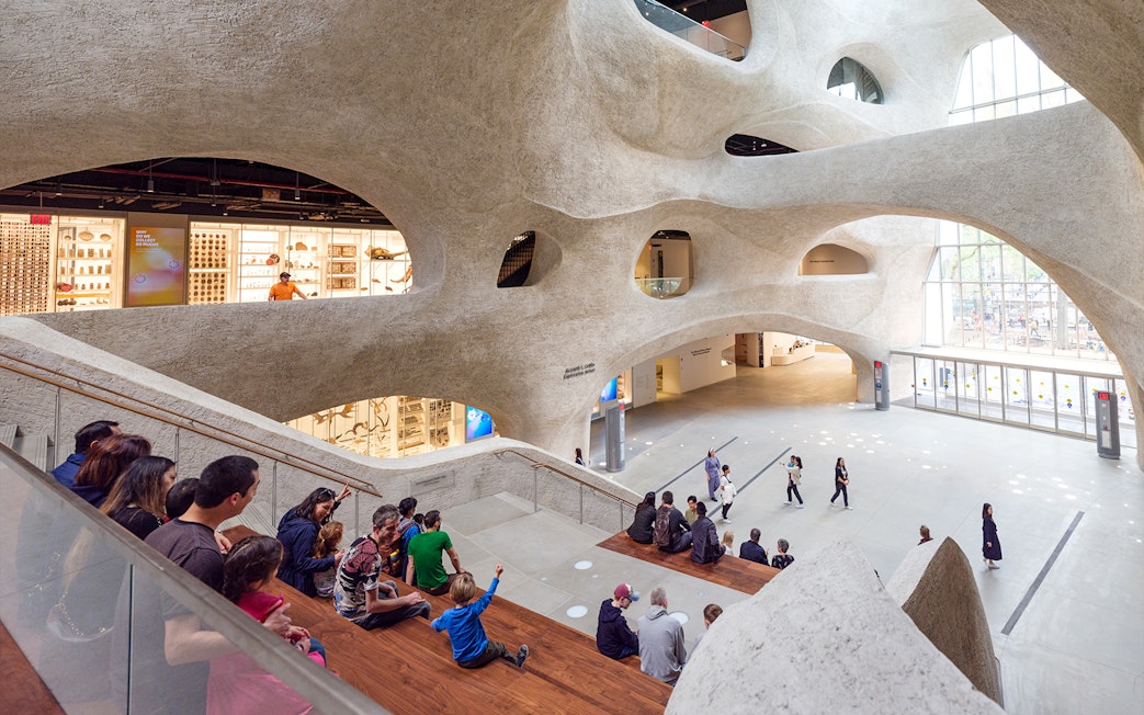 Visitors seated in the American Museum of Natural History's modern atrium, New York City.