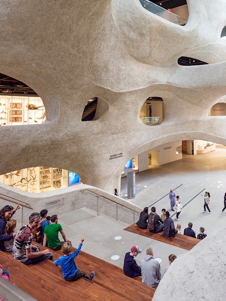Visitors seated in the American Museum of Natural History's modern atrium, New York City.