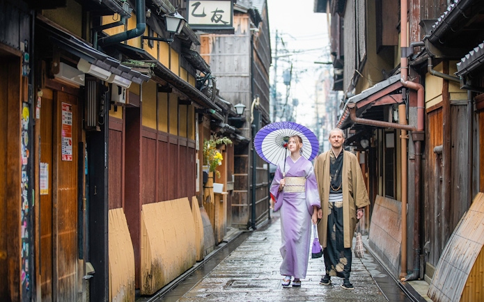 Guests in traditional kimonos walking in a Kyoto street after visiting a kimono rental.