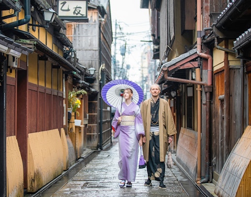 Woman in traditional kimono walking through Gion district, Kyoto, during full-day rental experience.