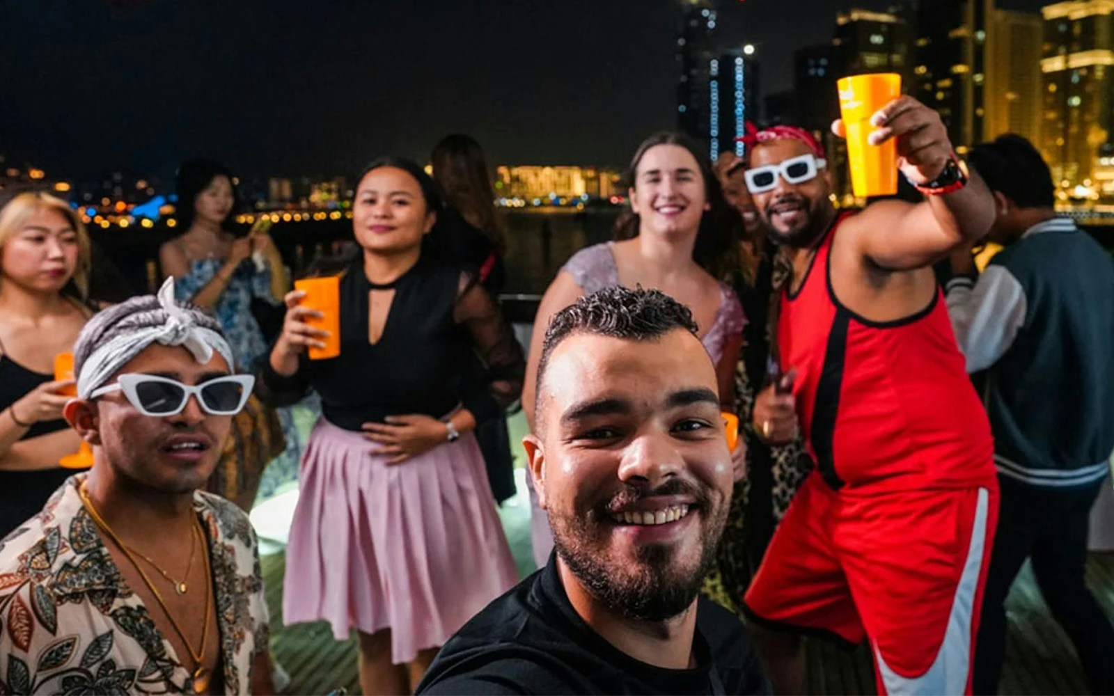 Friends enjoying a yacht party with BBQ and drinks at Dubai Marina.