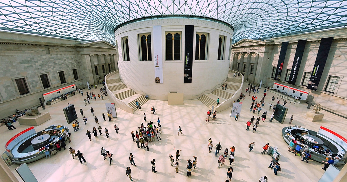 Visitors exploring the Great Court of the British Museum, London, beneath the glass roof.