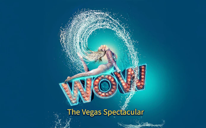 Performer in mid-air pose with water splash, "WOW" sign, Vegas show.