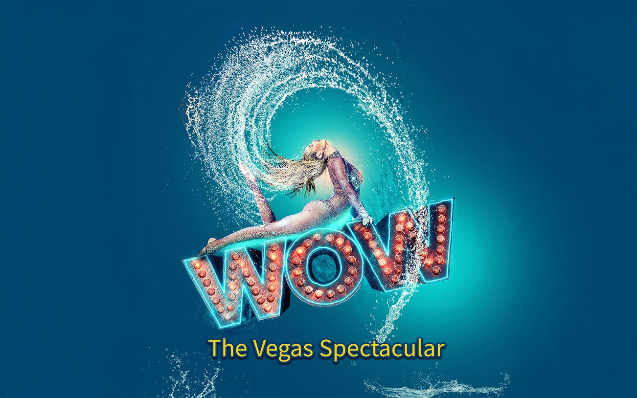 Performer in mid-air pose with water splash, "WOW" sign, Vegas show.