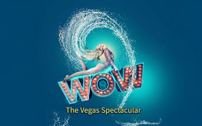 Performer in mid-air pose with water splash, "WOW" sign, Vegas show.