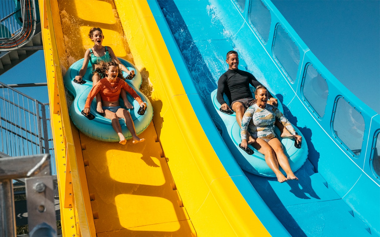 Tourists sliding down water slides at Kaboom, Wet n Wild.