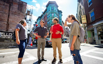 Group of people exploring Boston's North End along the Freedom Trail.